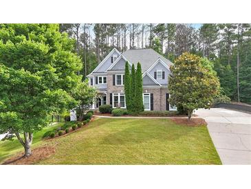 Beautiful two-story home featuring a well-manicured lawn and a mix of brick and siding at 212 Thorncliff Way Way, Acworth, GA 30101