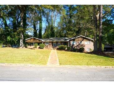 Charming one-story home with mature trees and a sprawling front yard at 2234 Clifton Springs Mnr, Decatur, GA 30034