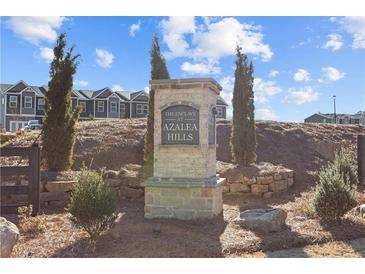 Stone community sign for 'The Enclave at Azalea Hills' with landscaping and community homes visible in the background at 109 Meadowview Dr, Temple, GA 30179