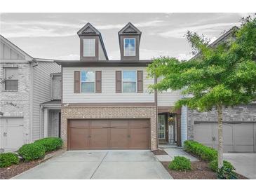 Charming two-story townhouse with a two-car garage and manicured landscaping, providing great curb appeal at 3246 Spicy Cedar Ln, Lithonia, GA 30038