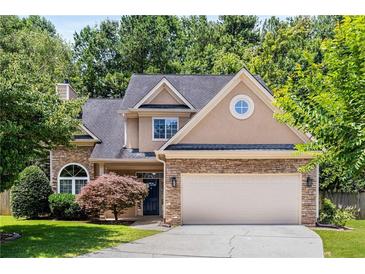 Charming two-story home with stone accents, manicured lawn, and attached two-car garage at 2102 Berryhill Se Cir, Smyrna, GA 30082