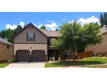 Charming two-story home featuring a two-car garage, manicured lawn, and mature tree, offering curb appeal at 312 Sierra Ct, Mcdonough, GA 30253