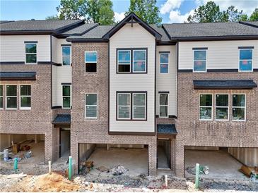 Modern townhome with brick facade, attached garages, and neutral-toned siding at 6 Rock Park Way # 15, Tucker, GA 30084