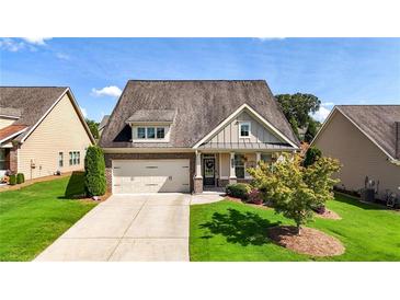 Charming single-Gathering home with a well-manicured lawn and two-car garage at 5640 Hammock Way, Cumming, GA 30028
