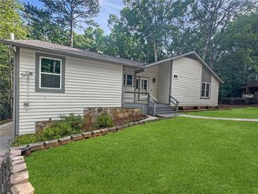 Charming single-Gathering home featuring well-manicured lawn and classic siding at 6800 Brookwood Ct, Douglasville, GA 30135