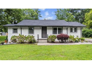 Charming single-story home with a well-maintained lawn and tidy landscaping at 5599 Redan Cir, Stone Mountain, GA 30088