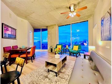 Bright living room with hardwood floors, floor to ceiling windows, and an open floor plan at 400 W Peachtree Nw St # 2704, Atlanta, GA 30308