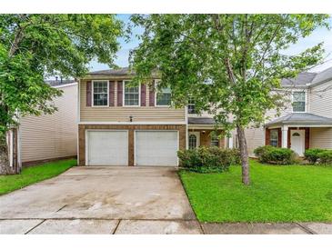 Charming two-story home with a two-car garage and a well-manicured lawn in a desirable neighborhood at 5865 El Segundo Way, Atlanta, GA 30349
