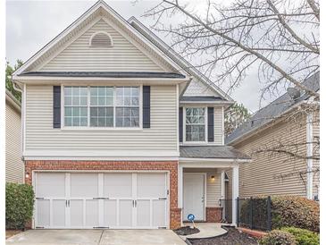Charming two-story home with brick accents and attached garage on a landscaped lot at 646 Lakes Cir, Lithonia, GA 30058