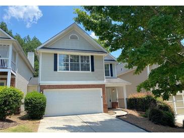 Charming two-story home with attached garage and nicely landscaped front yard at 646 Lakes Cir, Lithonia, GA 30058
