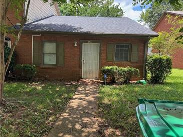 Charming brick home with a well-manicured front yard and green shutters at 4762 Old Highgate Entry, Stone Mountain, GA 30083