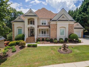 Beautiful two story home with brick and stucco exterior, manicured lawn, and tasteful landscaping at 4054 Lyon Blvd, Atlanta, GA 30331