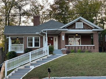 Charming brick home with a welcoming front porch and landscaped front yard at 1134 Donnelly Sw Ave, Atlanta, GA 30310