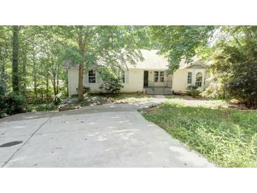 Charming single-Gathering home with mature trees and a spacious front yard and concrete driveway at 2773 Hawk Trace Ne Ct, Marietta, GA 30066