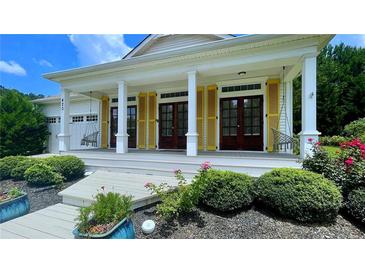 Charming front porch with yellow shutters and swing chairs at 420 Ashbury Cir, Dallas, GA 30157