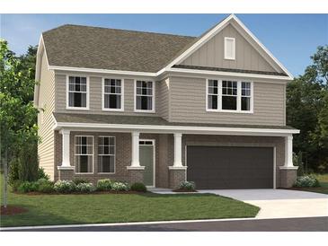 Charming two-story home with a covered porch, attached garage, and landscaped front yard at 7204 Eton Ln, Locust Grove, GA 30248