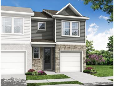 New two-story townhome features a stone and gray facade, a single-car garage, and lush landscaping at 514 Crown Dr, Emerson, GA 30137