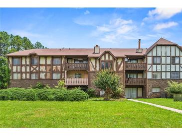 Inviting condo complex with well-maintained landscaping and Tudor-style facade at 115 Camelot Dr, Atlanta, GA 30349