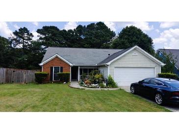 Charming single-story home with a well-manicured lawn, a screened porch, and an attached two-car garage at 20 Bacchus Dr, Lawrenceville, GA 30045