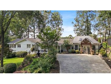 Charming home with lush landscaping, mature trees, and a circular driveway at 263 Mountainview Cir, Canton, GA 30115