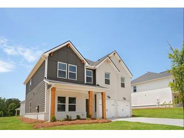 Beautiful two-story home featuring a covered front porch with wood columns and a two-car garage at 342 Orwell Drive Lot 95, Social Circle, GA 30025