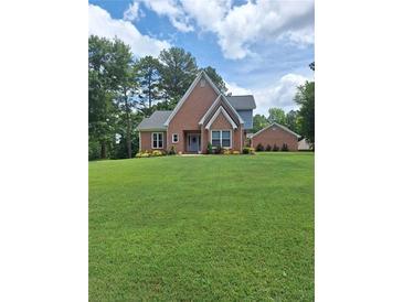 Charming brick home with a well-manicured lawn and mature trees in a peaceful setting at , Stockbridge, GA 30281
