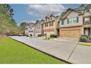 Charming townhomes featuring attached garages and well-manicured lawns at 2626 Sardis Chase Ct, Buford, GA 30519