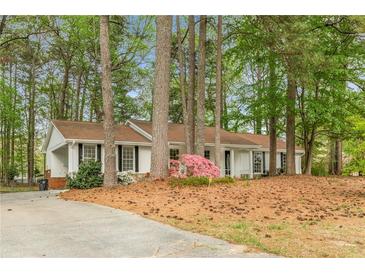 Charming one-story home with a well-maintained yard and mature trees provides a peaceful setting at 2694 Hickory Valley Dr, Snellville, GA 30078