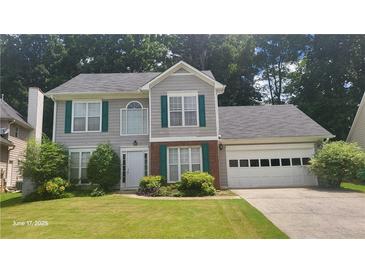 Charming two-story home featuring gray siding, green shutters and a well-maintained lawn at 3219 Roundfield Cir, Duluth, GA 30096