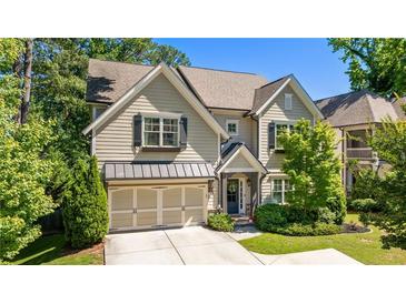 Charming two-story home with a well-manicured lawn, two-car garage, neutral siding, and black shutters at 1270 Briarwood Ne Rd, Atlanta, GA 30319
