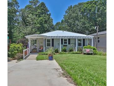 Charming single-story home with a well-manicured lawn, inviting front porch, and a cozy bench at 3131 Lee Cir, Buford, GA 30518