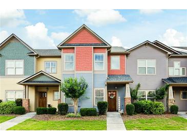 Charming townhouse with colorful exterior, landscaped front yard, and welcoming entryway at 4206 Mastic Pt # 24, Acworth, GA 30101