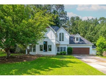 Charming two-story home with manicured lawn, lush landscaping, and a two-car garage at 5271 Oglethorpe Ct, Powder Springs, GA 30127