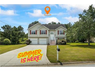 Charming two-story home with a well-manicured lawn and a spacious driveway at 185 Fox Run, Loganville, GA 30052