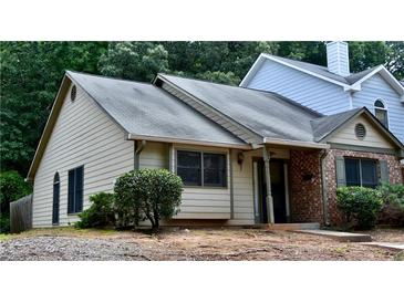 Charming home featuring a mix of siding and brick, complemented by lush landscaping and a welcoming entrance at 1106 Shiloh Nw Ln, Kennesaw, GA 30144