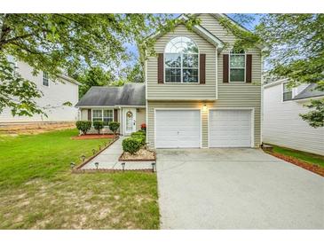 Charming two-story home with a well-manicured lawn, two-car garage, and inviting curb appeal at 191 Baywood Way, Hiram, GA 30141