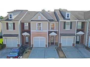 Charming townhome showcasing a well-maintained exterior with integrated garage and inviting front entrance at 3165 Creston Park Ct, Duluth, GA 30096