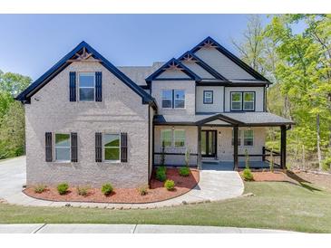 Charming two-story home with a combination of stone and siding, complemented by a well-maintained yard at 4208 Sierra Creek Ct, Hoschton, GA 30548