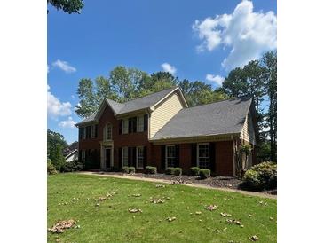 Charming two-story brick home with a well-maintained lawn and mature trees offering curb appeal at 160 Eastlake Nw Pt, Kennesaw, GA 30144