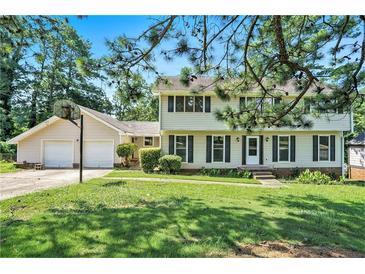Two-story home with a well-manicured lawn, black shutters, a basketball hoop, and an attached two-car garage at 5419 Ahyoka Dr, Morrow, GA 30260