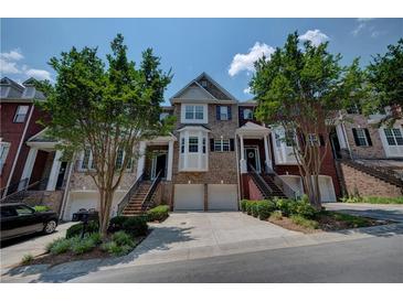 Charming townhome exterior featuring well-maintained landscaping and inviting entrances at 1622 Rivergreen Se Bnd # 26, Atlanta, GA 30339