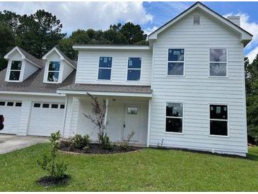 Charming two-story home with a manicured lawn and inviting curb appeal at 433 Rhett Dr, Loganville, GA 30052