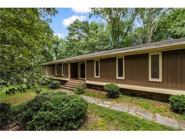 Charming home with verdant landscaping and inviting entryway at 4968 Twin Branches Way, Dunwoody, GA 30338