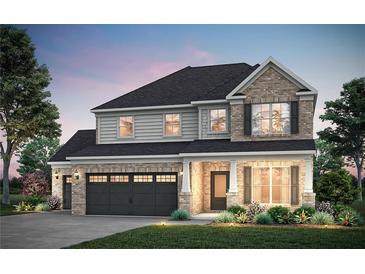 Charming two-story home featuring a brick and siding facade, a two-car garage, and manicured landscaping at 5315 Julep Ct, Cumming, GA 30028