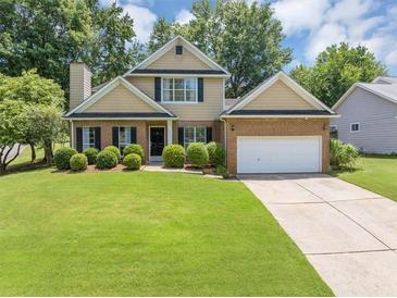 Charming two-story home with brick accents, lush lawn, and a two car garage at 10535 Willow Meadow Cir, Alpharetta, GA 30022
