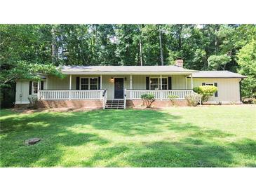 Charming single-story home featuring a well-maintained lawn and inviting front porch with brick accents at 180 Bishop Nw Rd, Cartersville, GA 30121