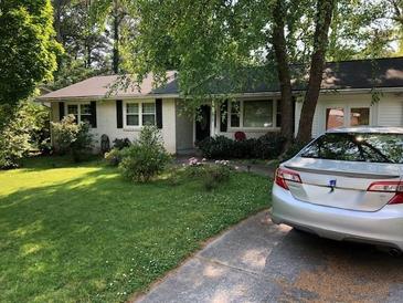 Charming single-story home with lush lawn, mature trees, and a welcoming front entrance at 2920 Appling Dr, Atlanta, GA 30341