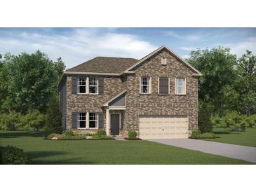 Charming two-story brick home with well-manicured lawn and attached two car garage at 512 Almere Dr, Hampton, GA 30228