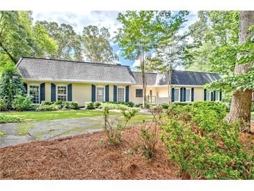 Charming single-story home with a well-maintained lawn, mature trees, and classic curb appeal at 522 Golfview Dr, Peachtree City, GA 30269