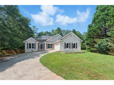 Charming single-story home featuring stone accents, fresh exterior paint and a well-manicured lawn at 75 Fox Chase, Covington, GA 30016